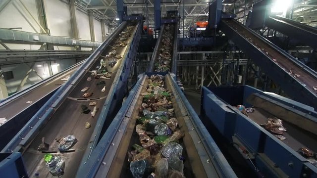 Waste processing plant. Waste on shipping tape. Waste sorting