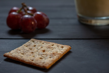 Breakfast with wholemeal cookies, fruits and drink on a rustic background.