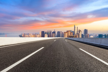 Fototapeta premium Empty asphalt road and city skyline in Hangzhou at sunrise,high angle view