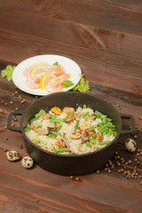 Aluminum non-stick cookware with vegetables on wooden background