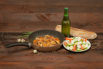 Aluminum non-stick cookware with vegetables on wooden background