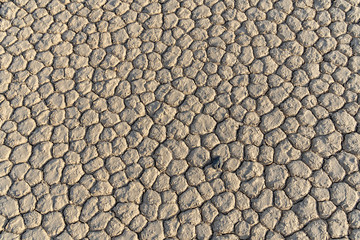 Dry lake bed formed polygon patterns, usually 6 sided, Racetrack Playa with a single black rock, Death Valley National Park, California