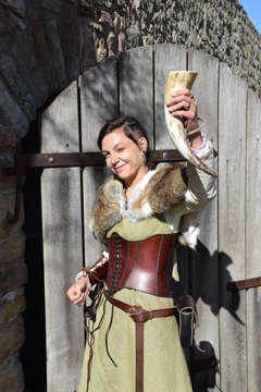 Smiling Celtic princess toasts to the people