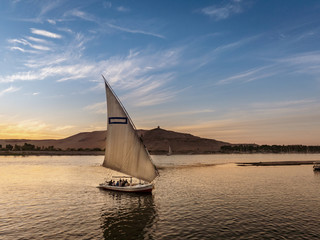 Tourist taking a ride in a Felucca boat in Luxor Egypt on the NIle River - 243678124
