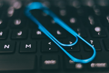 laptop keyboard with clip symbol of email attachments