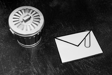 envelope with clip symbol of email and attachments with trash can next to it