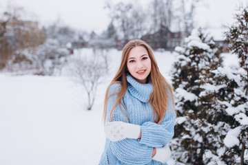 Close up winter portrait of young positive happy freedom hipster caucasian pretty fashionable girl outdoors in winter park smiling and having fun