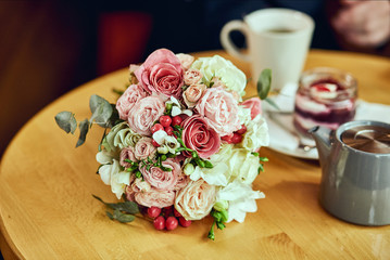 bridal bouquet  lie in cafe on a table. Wedding acsessories