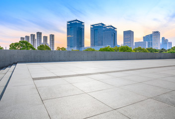 Empty square floor and city skyline with buildings in Shanghai at dusk