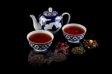 tea on a black background with reflection