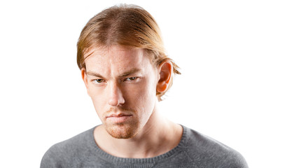 Obraz premium Male portrait of a fair-haired man of European appearance, on a white background. Emotions.