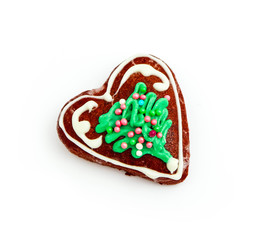 Homemade gingerbread Christmas cookie in a shape of heart, isolated on white. Holiday decoration, winter time food.