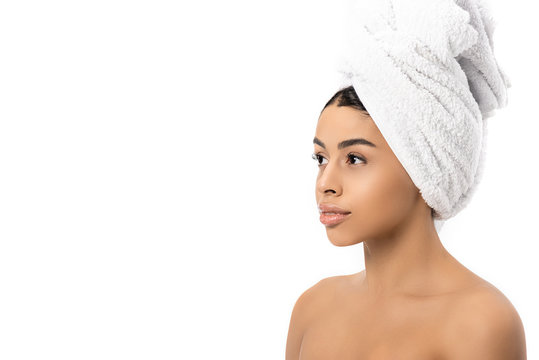 portrait of beautiful pensive african american girl with towel on head looking away isolated on white