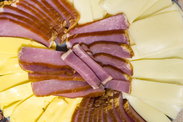 Cutting from cheese and meat products on plate