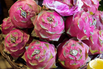 Close-up of red ripe pitayas or white pitahayas dragon fruits on market