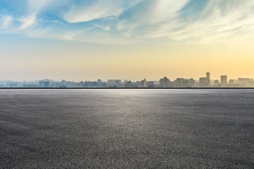 Panoramic city skyline and buildings with empty asphalt road at sunrise - obrazy, fototapety, plakaty