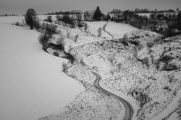Naklejka na ściany i meble Landscape with road at winter on Ponidzie near Stradow, Swietokrzyskie, Poland
