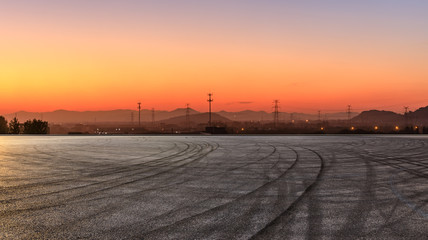 Fototapeta na wymiar Empty asphalt road and mountains at beautiful sunset,panoramic view