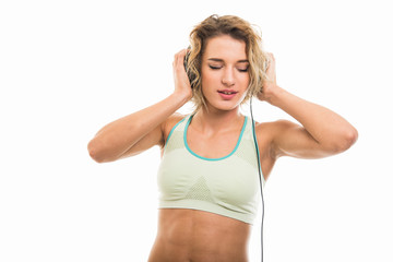 Portrait of fit girl listening to headphones