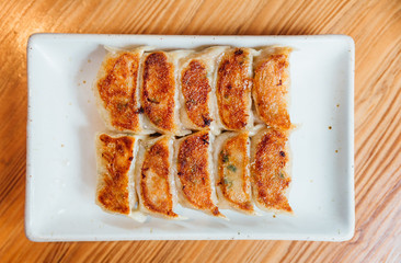 Yaki-Gyoza set (Japanese Pan-Fried Dumplings) served on white plate.