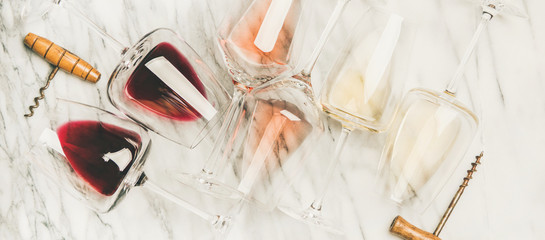 Red, rose, white wine in glasses and corkscrews, horizontal composition