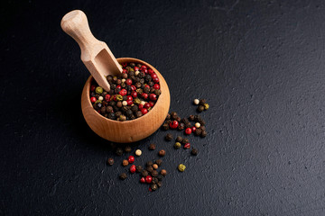 black pepper in wooden spoon