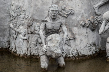 The National Monument - statues in the walls at Memorial tower in the centre of Merdeka Square, Jakarta. Symbolizing the fight workers for Indonesia.
