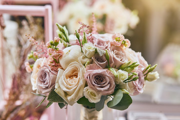 beautiful wedding bouquet with roses standing on the table