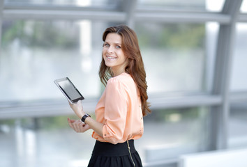 side view.confident business woman with digital tablet