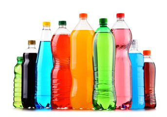 Plastic bottles of assorted carbonated soft drinks over white