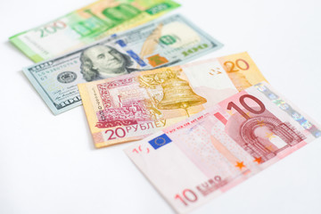 Fototapeta na wymiar American dollar, European euro, Belorussian and Russian Rouble bills on white background