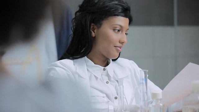 Young science student receiving test results, slow motion