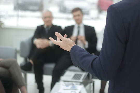 Close Up. Businessman Reading A Report At A Working Meeting