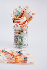Russian rubles in jar on white background. Copy space. Loan, mortgage, credit, deposit concept