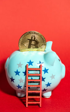 Blue piggy bank and ladder. Bitcoin coin on the piggy. Concept for bitcoin cripto money savings and success.