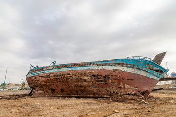 An old shipwreck boat abandoned stand on beach or Shipwrecked off the coast of Jeddah Saudi Arabia.
