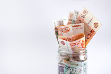 Russian rubles in jar on white background. Copy space. Close up. Loan, mortgage, credit, deposit concept