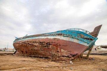 An old shipwreck boat abandoned stand on beach or Shipwrecked off the coast of Jeddah Saudi Arabia.
