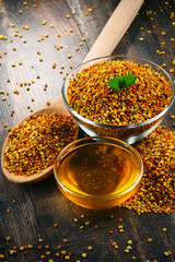Bowls with bee pollen and honey on kitchen table