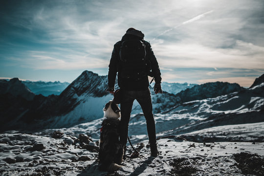 Owner with dog on mountain
