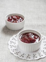Homemade strawberry sweet delicious jam with whole berries on white background