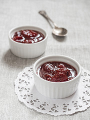 Homemade strawberry sweet delicious jam with whole berries on white background