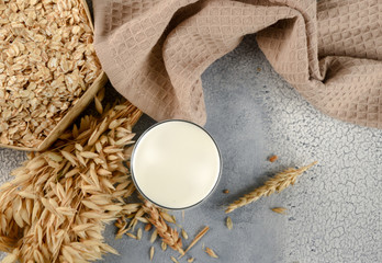 The concept of a vegetarian diet. Oat milk in the glass and oat and oat ears. Top view