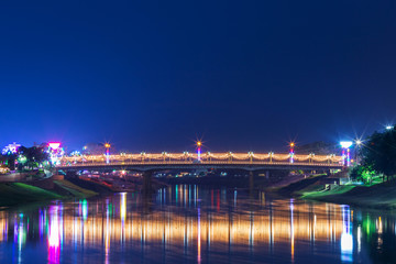 Fototapeta na wymiar Beautiful light on the Nan River at night on the bridge (Naresuan Bridge) in Phitsanulok City,Thailand.
