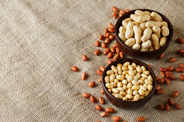 Peanuts in the shell and peeled closeup in a cup