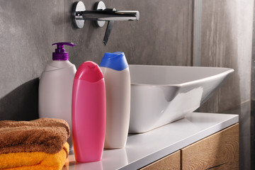 Plastic bottles of body care and beauty products in the bathroom