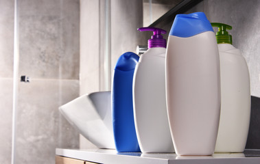 Plastic bottles of body care and beauty products in the bathroom