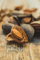 Almonds on wooden board close up