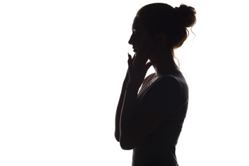 silhouette of a calm young woman on a white isolated background, figure of girl with hands on her face