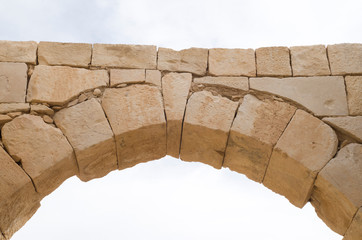Ancient stone arch and keystone in the sky